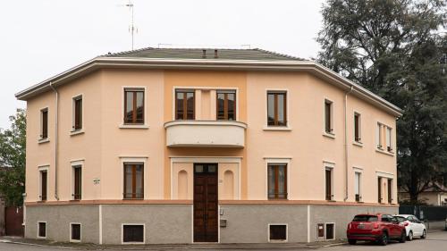 a building with a red car parked in front of it at VigevanoRent in Vigevano
