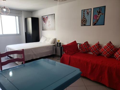 a living room with a couch and a bed at Flat Centro de São Paulo in Sao Paulo