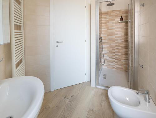 a bathroom with a white sink and a shower at VigevanoRent in Vigevano