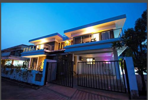 a large house with a fence in front of it at Woods by Mizzle Exotica Premium Villas in Lonavala