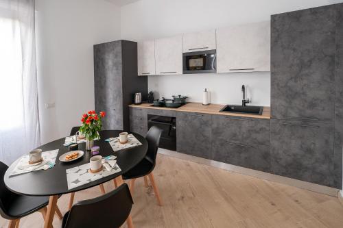 a kitchen and dining room with a table and chairs at VigevanoRent in Vigevano