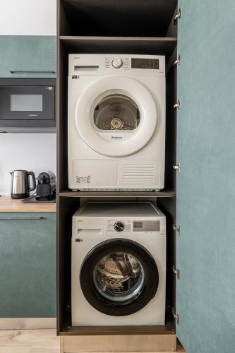 a dryer and a washing machine in a cabinet at VigevanoRent in Vigevano
