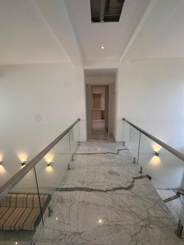 a staircase in a building with a marble floor at Woods by Mizzle Exotica Premium Villas in Lonavala