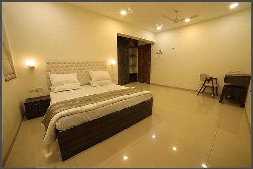 a bedroom with a large bed in a room at Woods by Mizzle Exotica Premium Villas in Lonavala
