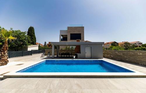 a swimming pool in the backyard of a house at Villa Gina in Sukošan