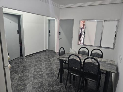 a dining room with a table and chairs at CIG Hostel in Goiânia