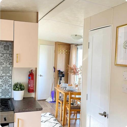 a small kitchen and dining room with a table at Beatrice homes in Parkeston