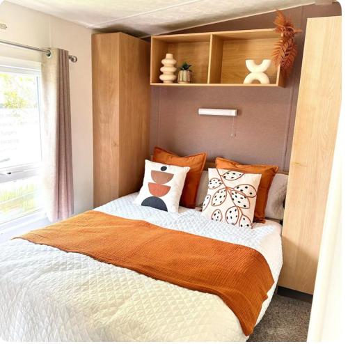 a bedroom with a bed with pillows on it at Beatrice homes in Parkeston