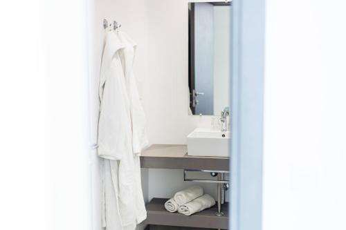 a bathroom with a sink and a mirror at Flamingo Hotel Malta in St Julian's
