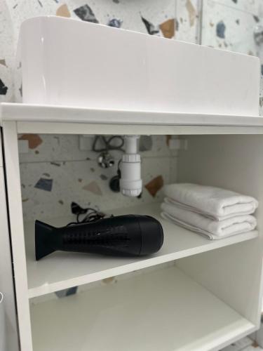 a black bottle on a shelf under a sink at Apartment suite Mukachevo in Mukacheve