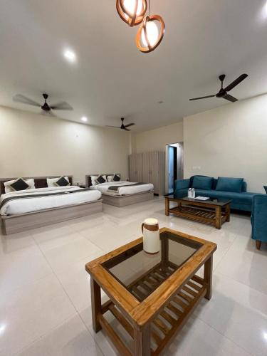 a living room with two beds and a couch at HOTEL KAVANA in Varanasi