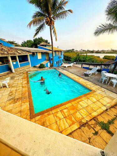 a person in a swimming pool in a house at Pousada Novo Horizonte in Búzios