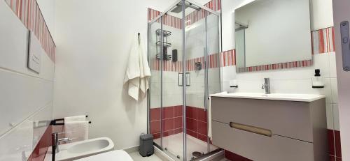a bathroom with a glass shower and a sink at Casa Sunrise - The Guest House in Sciacca
