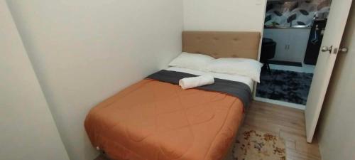 a small bed in a corner of a room at Vian'z Condotel in Naga