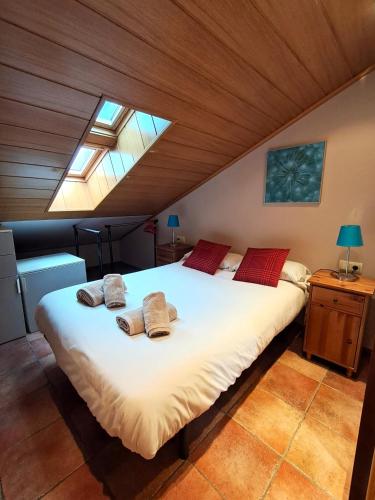 a bedroom with a large white bed with red pillows at PROBER-CHAMOIX 68 in Encamp