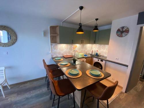 une cuisine avec une table et des chaises dans une cuisine dans l'établissement Studio - Les Cigales De Mer - Centre Ville -100 m de la plage, au Grau-du-Roi