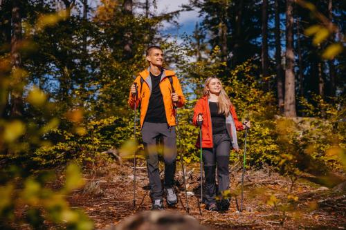 a man and a woman walking on a trail at Five Seasons Szklarska Poręba in Szklarska Poręba