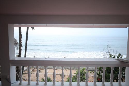 a view of the beach from a balcony at Le Serene Independent Beach Villa in Kottakupam