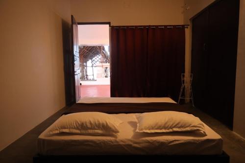 a bedroom with two beds and a window at Le Serene Independent Beach Villa in Kottakupam
