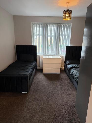 a living room with two beds and a couch at WoolPack in Huddersfield