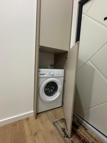 a laundry room with a washing machine in a closet at Apartment suite Mukachevo in Mukacheve