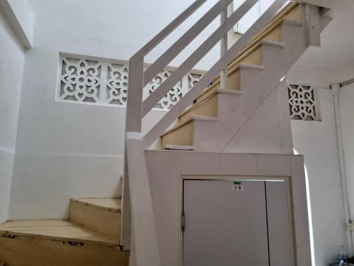 a staircase in a house with a stair case at Haus Sathorn Pier 2 Cozy Bedroom City Center in Bangkok