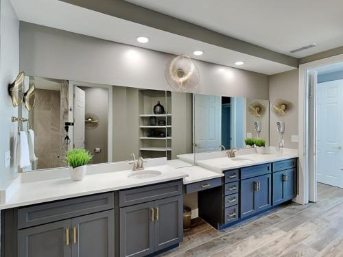 a bathroom with two sinks and a large mirror at The Beach Club - Catalina Penthouse #2 in Gulf Highlands