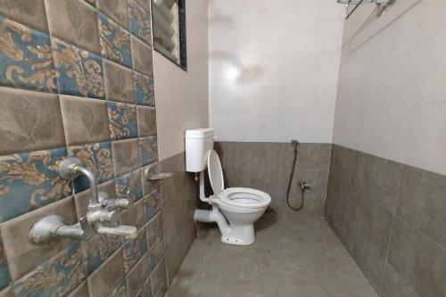 a bathroom with a toilet and a shower at Yashraj Resorts in Pune