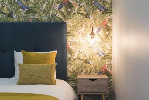 een slaapkamer met een bed met tropisch behang bij Sta Catarina - 2 Bedroom Apartament in Porto