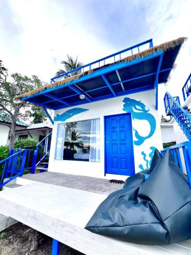 a small house with a blue door and a blue porch at Three Trees Samui Resort - Sarocha Villa in Lamai