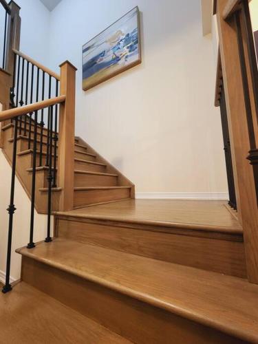 a set of stairs with a painting on the wall at Majestic Elegance-15 mins-Niagara Falls & 10 mins-Brock University in Thorold