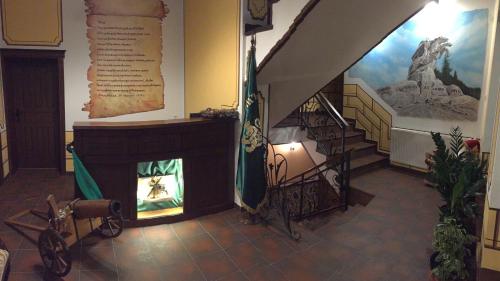 a room with a fireplace and stairs in a building at Stoichkovata Kashta Koprivshtitsa in Koprivshtitsa