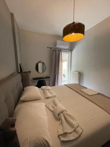 a bedroom with a bed with towels on it at Anais apartment in Preveza