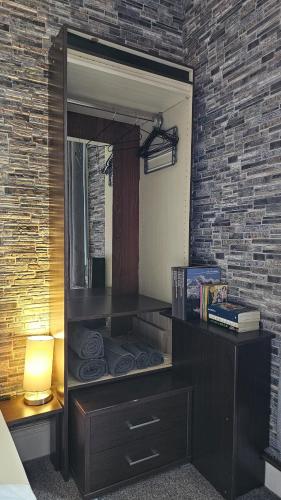 a dresser with a mirror in a bedroom at Moorburn Heights in Largs