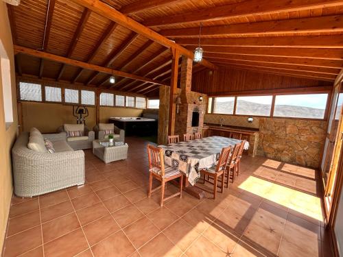 a large living room with a table and chairs at Casa Tortuga in Tarajalejo