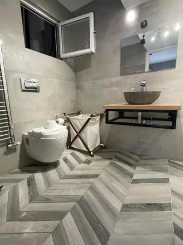 a bathroom with a sink and a toilet at Anais apartment in Preveza