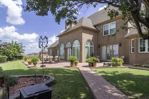 a large brick house with a grass yard at 5-Bedroom Home to Texoma lake and Casino in Durant