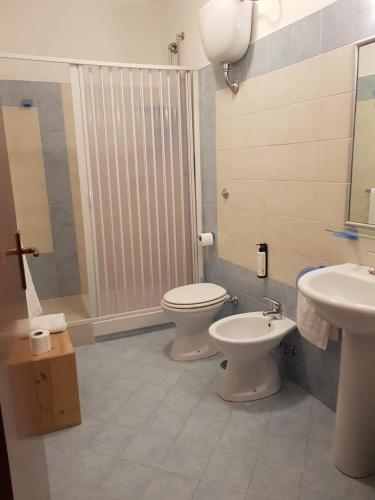 a bathroom with two toilets and a shower and a sink at B&B La Piazzetta in Paola