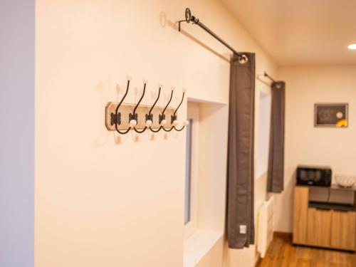 Cette chambre est dotée d'un mur avec des cintres sur le mur. dans l'établissement Magnifique Studio Arles, à Arles