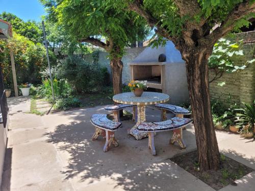 a table and two chairs and a tree at Las Violetas in Lobos