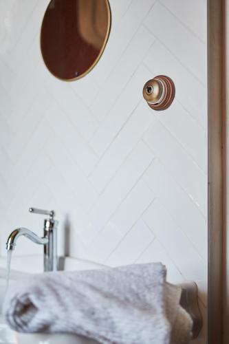 a bathroom sink with a mirror and a towel at Manoir la grande guerais in Beaussais sur Mer