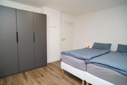 a bedroom with a large bed and a closet at Ada Düne in Helgoland