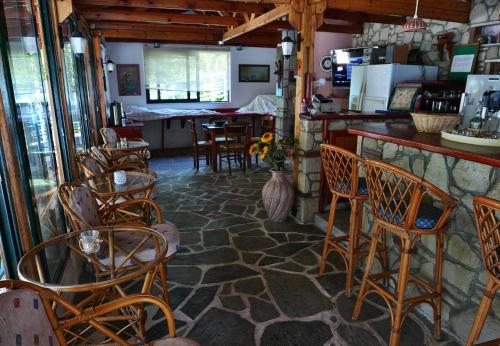 a room with a bar with chairs and a counter at Kastro Studios Apartments in Myrtos