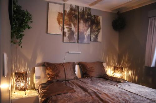 a bedroom with a bed with two lights on it at Veluwe Park Reewold Chalet Eclipse in Putten