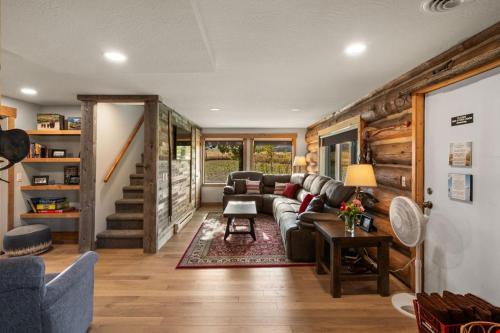 a living room with a couch and a stairway at UC River Ranch in Emigrant