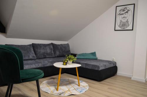 a living room with a couch and a table at LevelUP1 in Ðakovo
