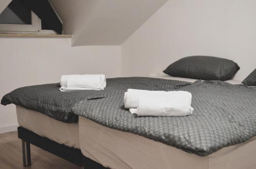 a bedroom with two beds with white towels on them at LevelUP1 in Ðakovo