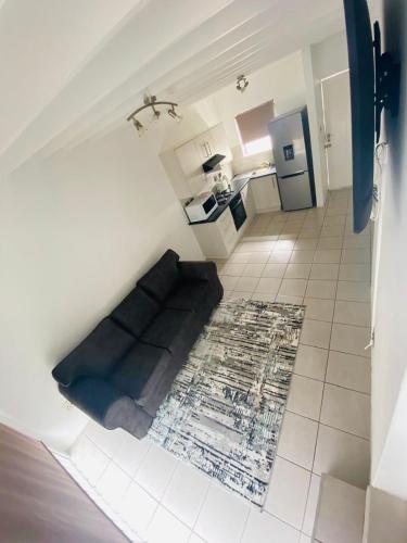 a living room with a couch in the middle of a kitchen at Luxury Suites at St Petes Duplex Townhouse in Newton Park