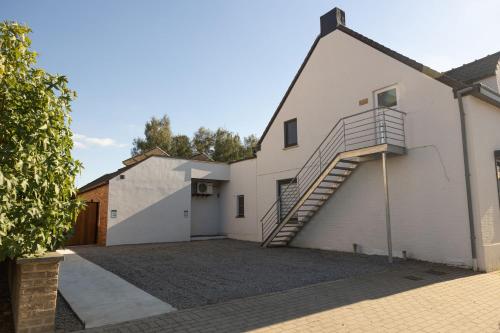 a house with a staircase on the side of it at Alivio - Thuiskomen bij jezelf op vakantie in Lummen