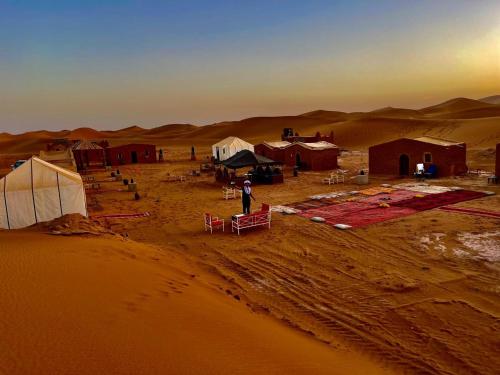 a group of tents in the middle of a desert at Desert Erg Chegaga Camp in El Gouera